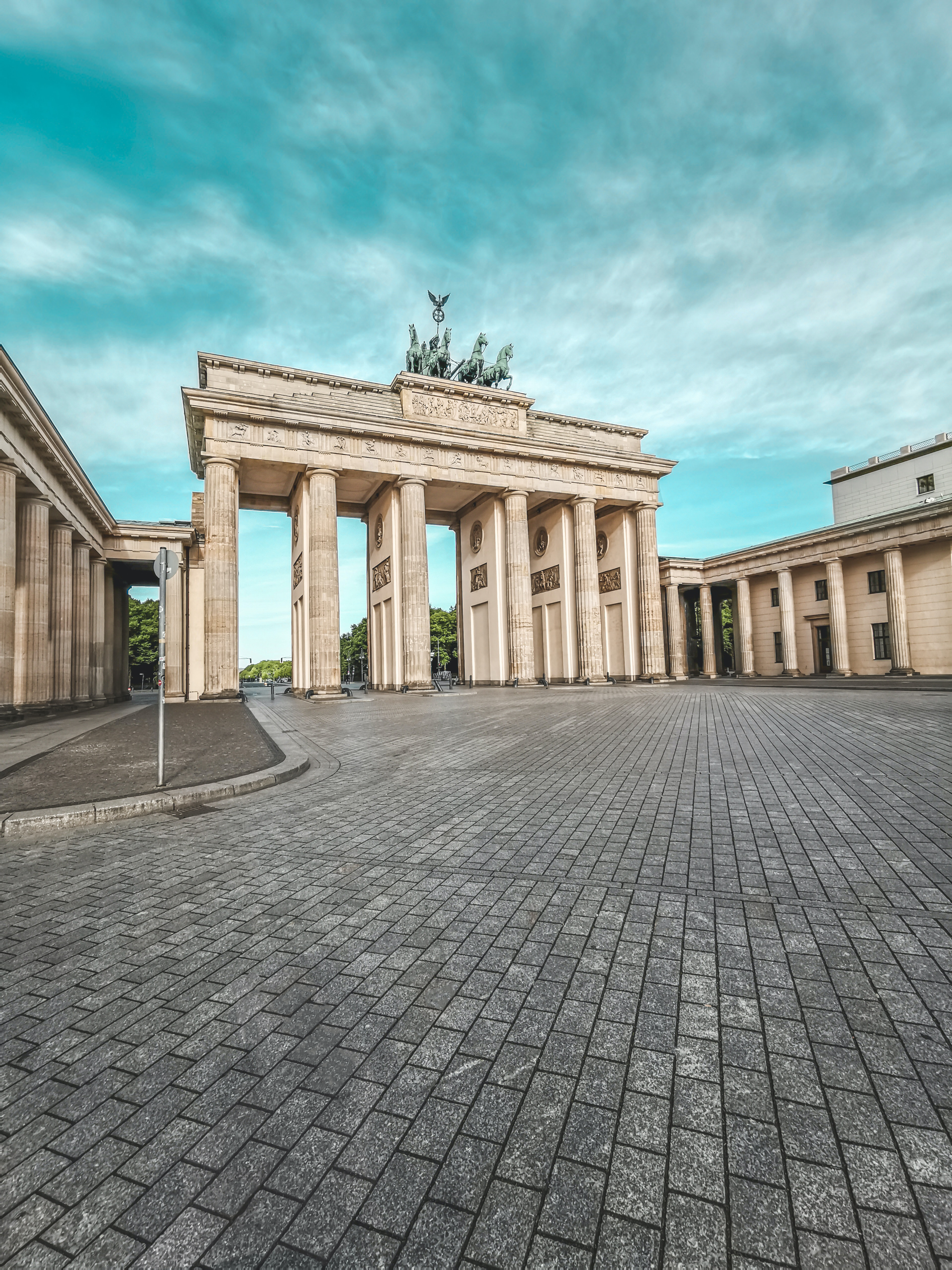 a stone arch with a statue on top of it