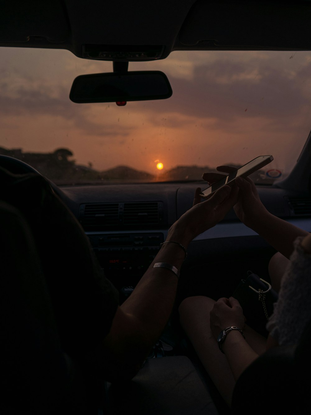 a couple of people sitting in the back of a car