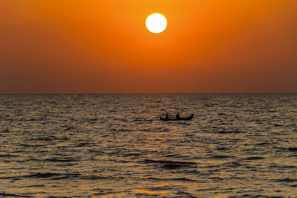 a couple of boats floating on top of a large body of water