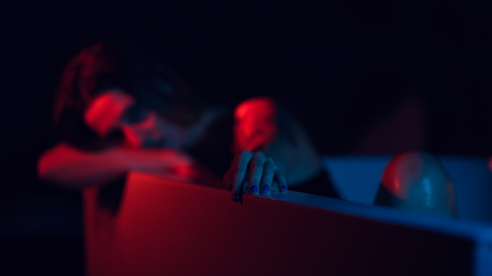 a woman is sitting in a red chair