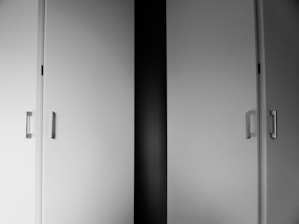 a black and white photo of two doors