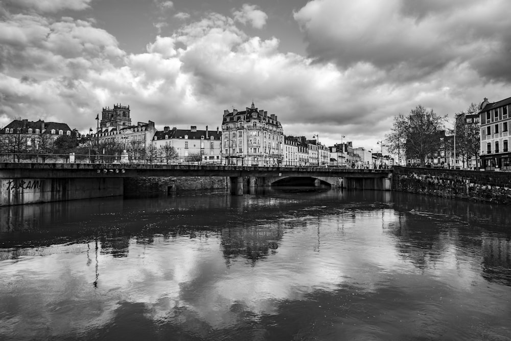 a black and white photo of a bridge over a river