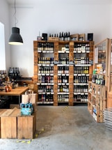 A cozy store counter with various bottles of beverages displayed neatly.