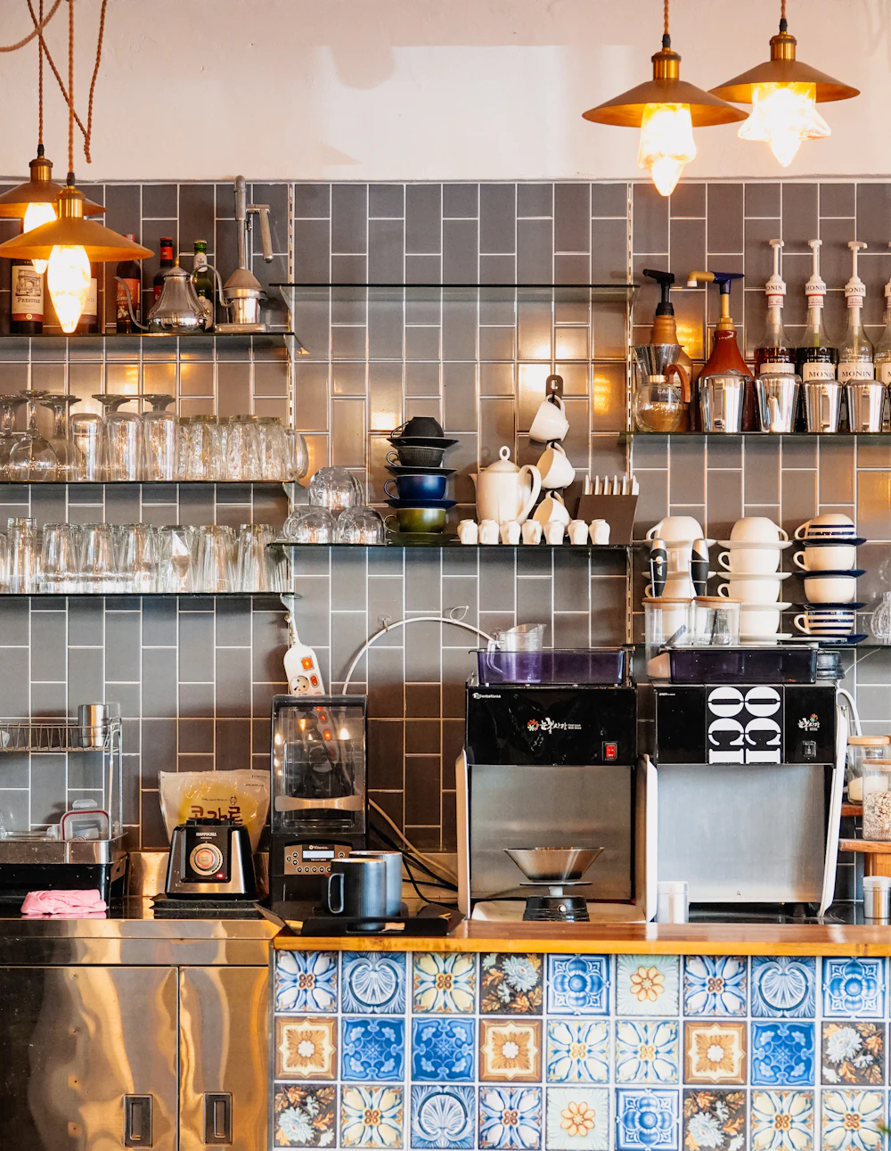 Espresso bar counter with rows of cups at the Hive Workspace roastery