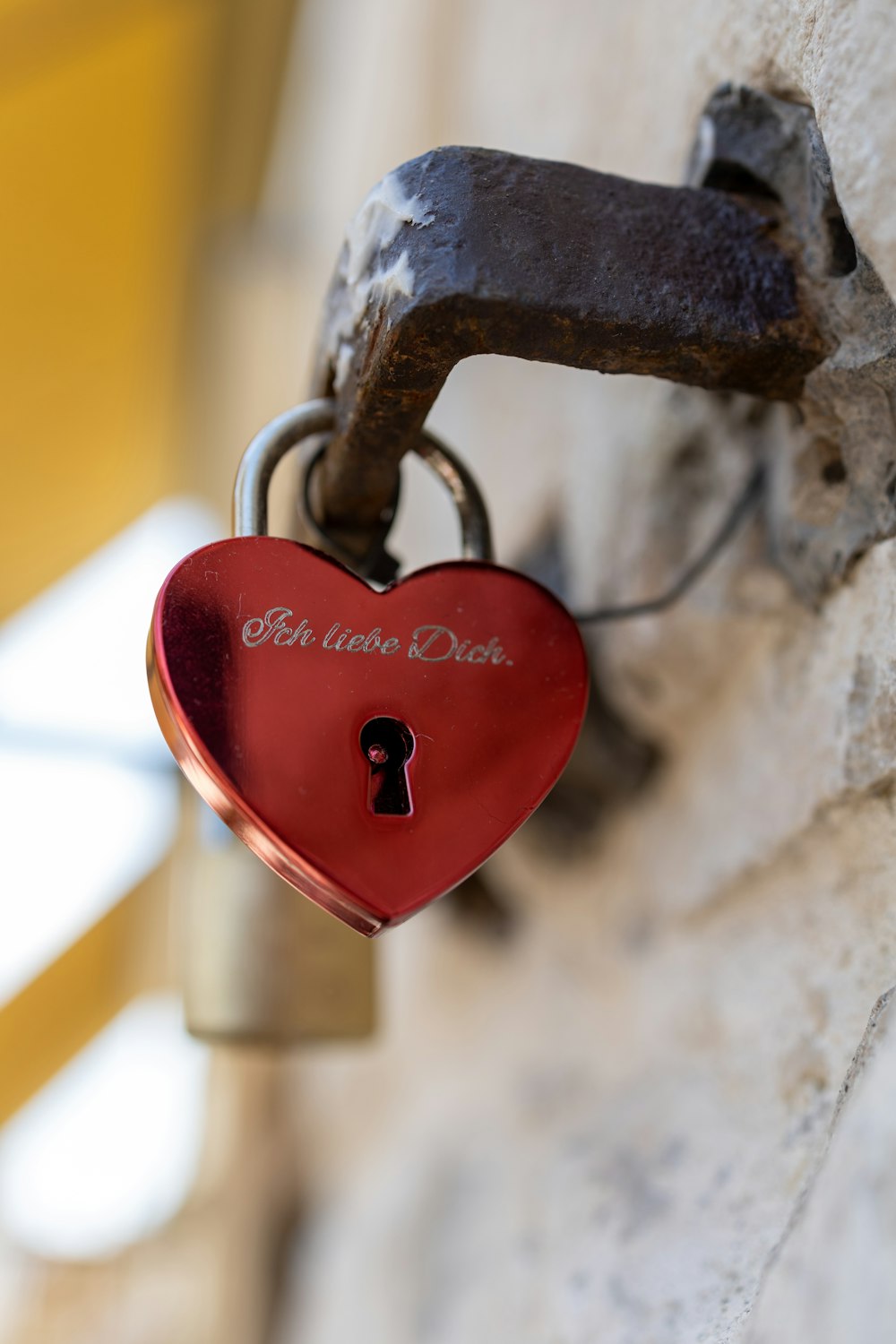 a heart shaped padlock attached to a wall