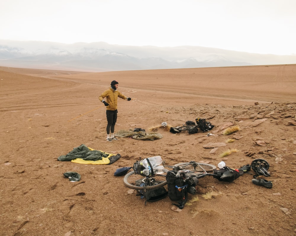 a man standing in the middle of a desert