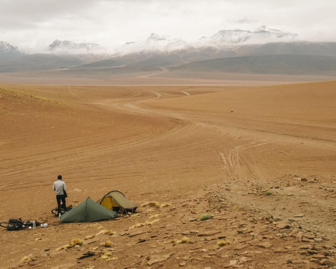 a man standing next to a tent in the desert, Setting up camp.<p></figure>In 2018, two friends, Bryn and Stu, embarked on a cycling trip across South America. With a limited budget and an incredibly light set up, they decided on a route that capitalised on some of the continent