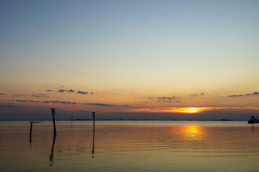 the sun is setting over a body of water