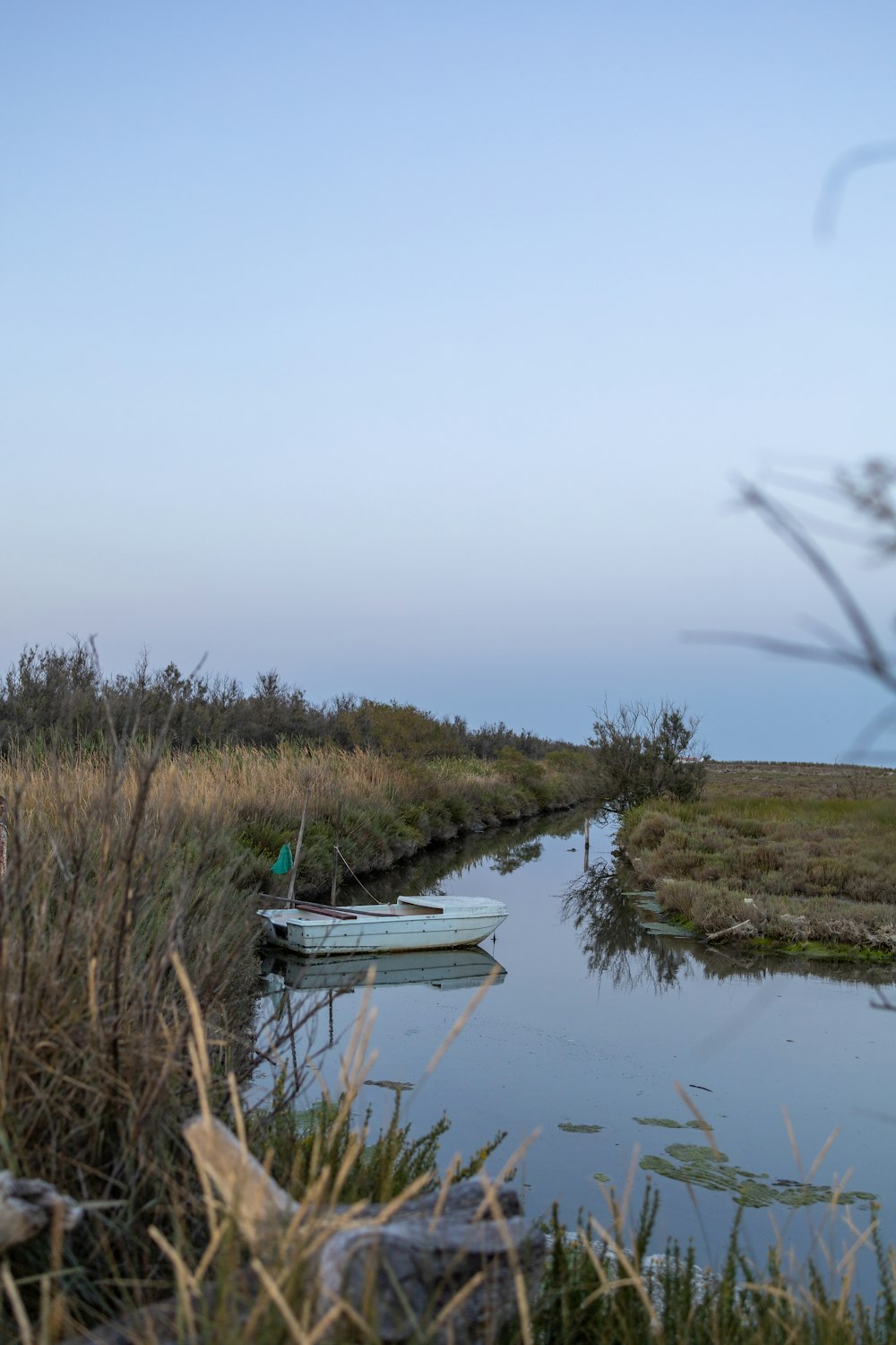 a couple of small boats floating on top of a river