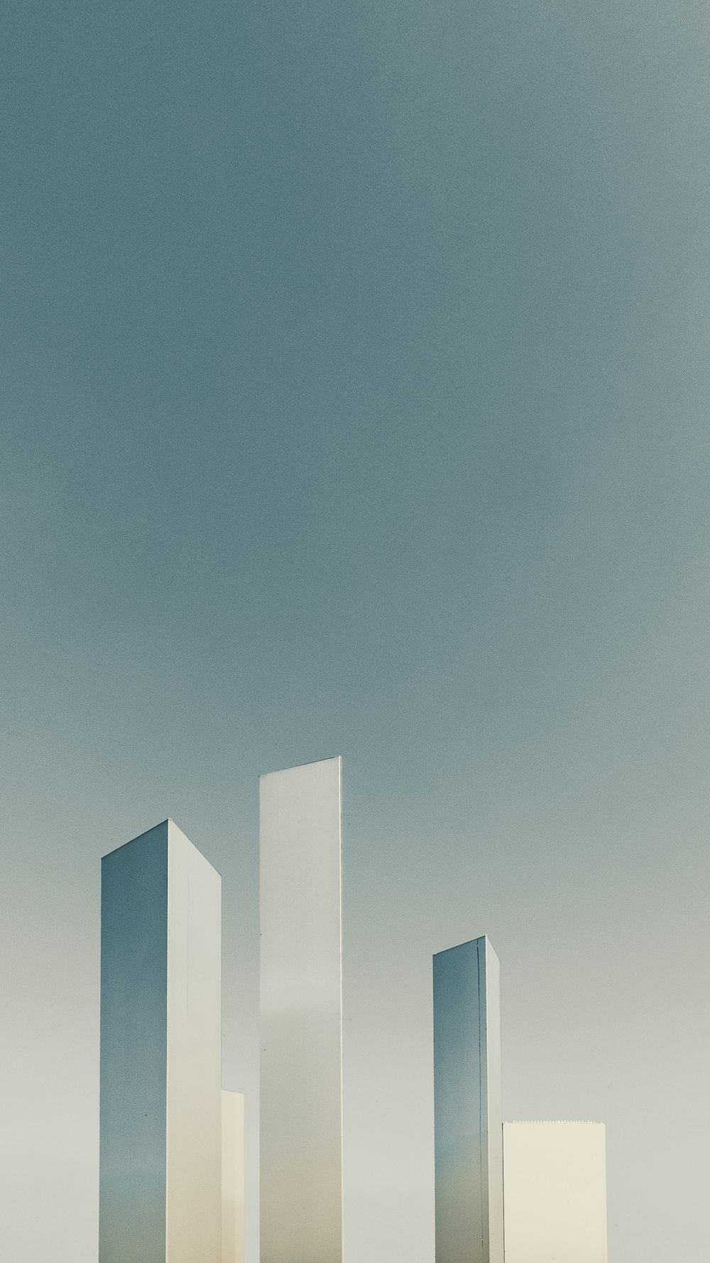 a group of tall white buildings sitting next to each other