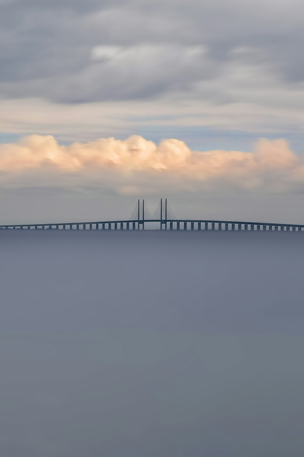 a large long bridge spanning over a large body of water