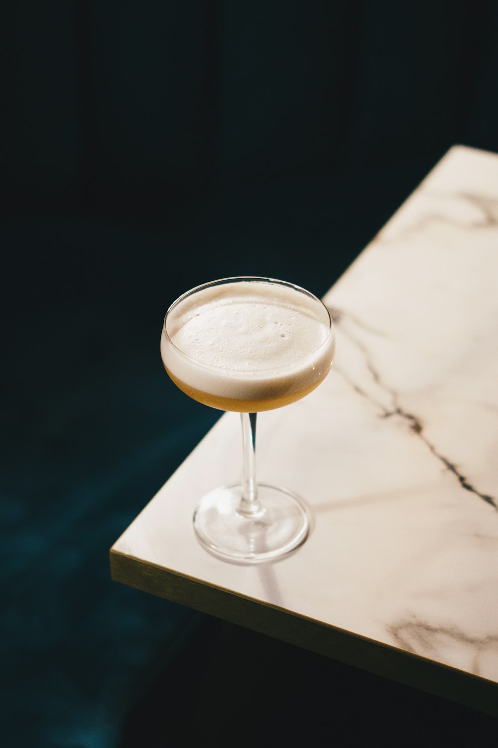 a drink sitting on top of a marble table