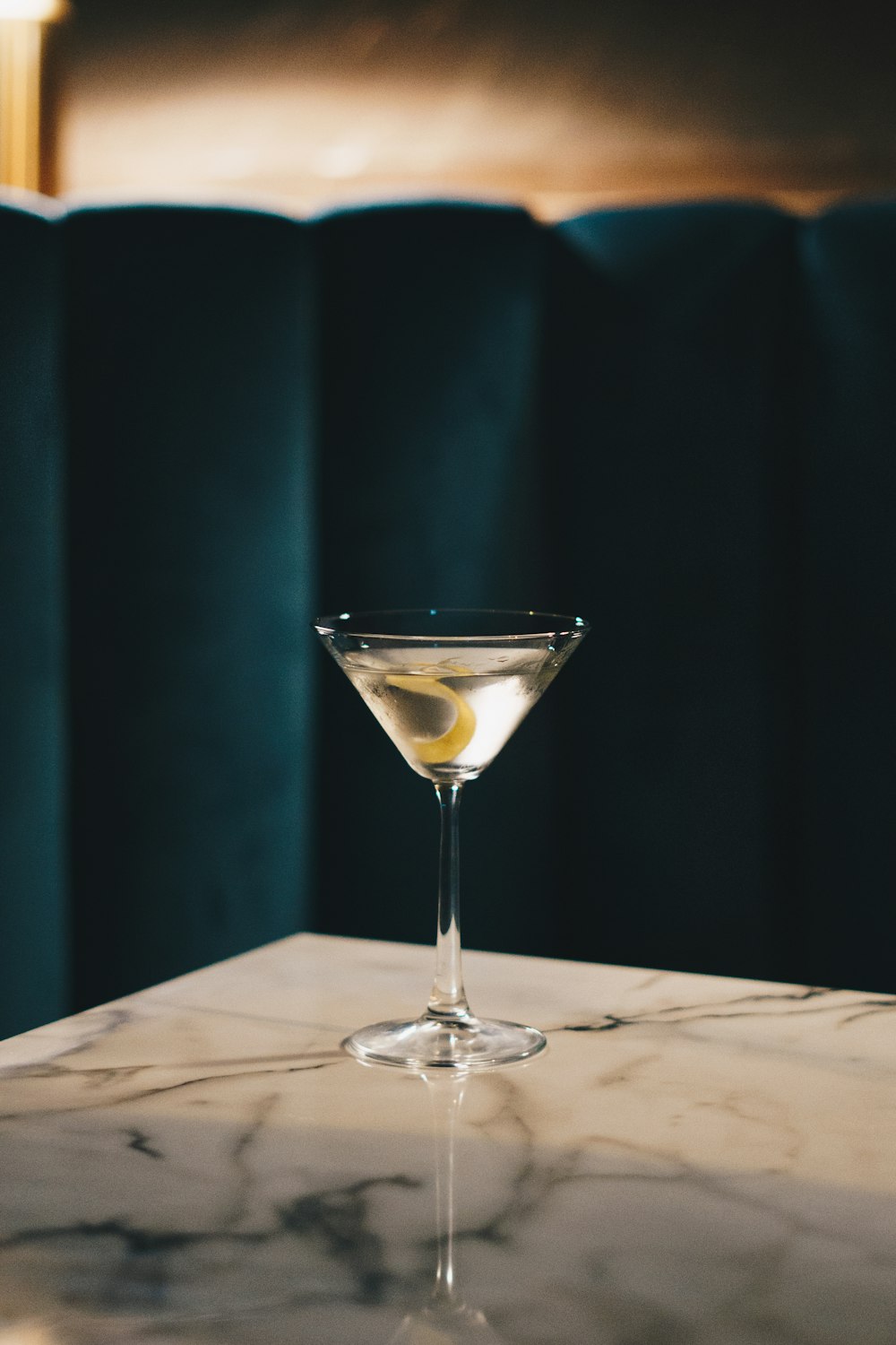 a martini sitting on top of a marble counter