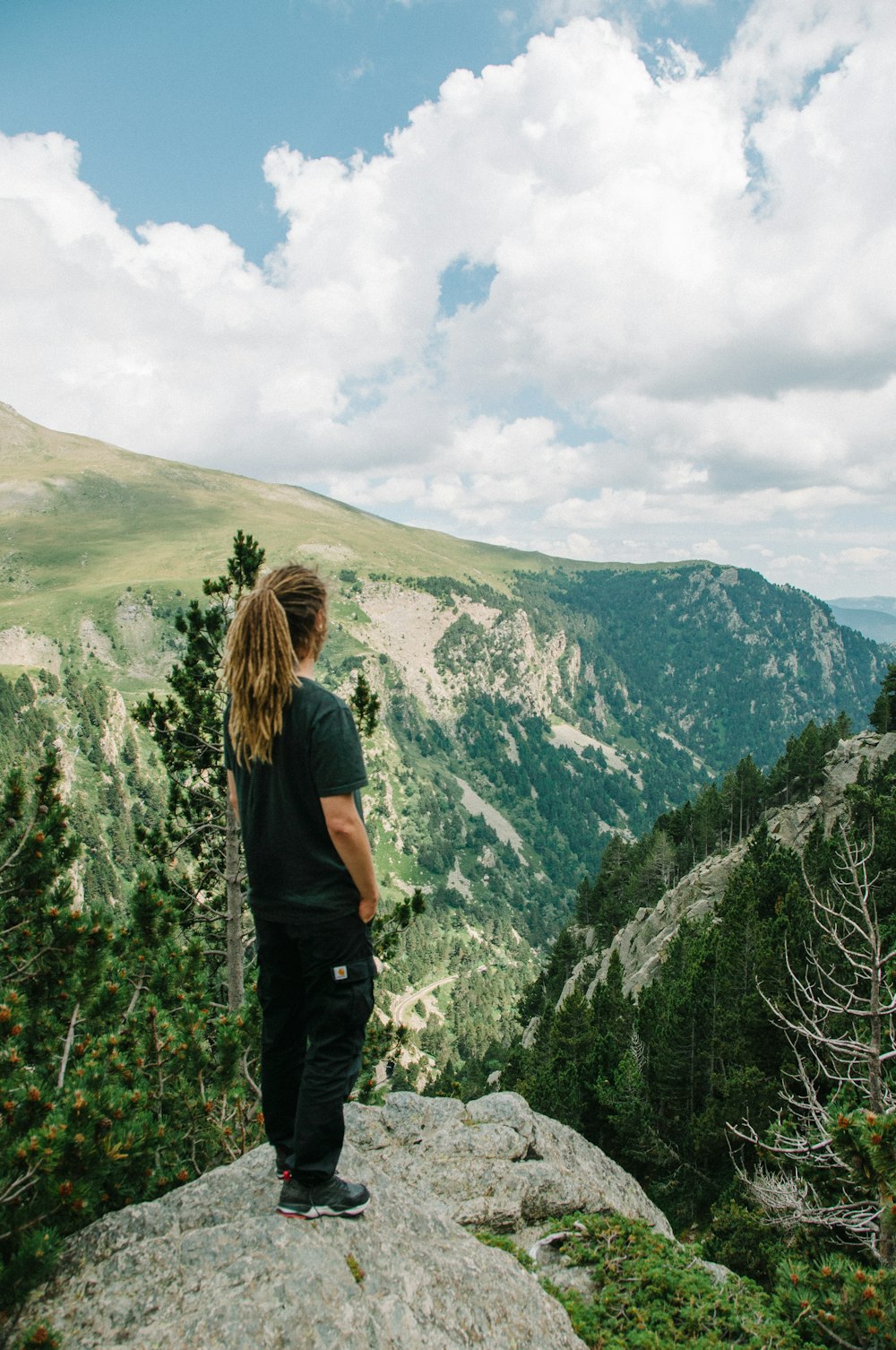 a man standing on top of a large rock