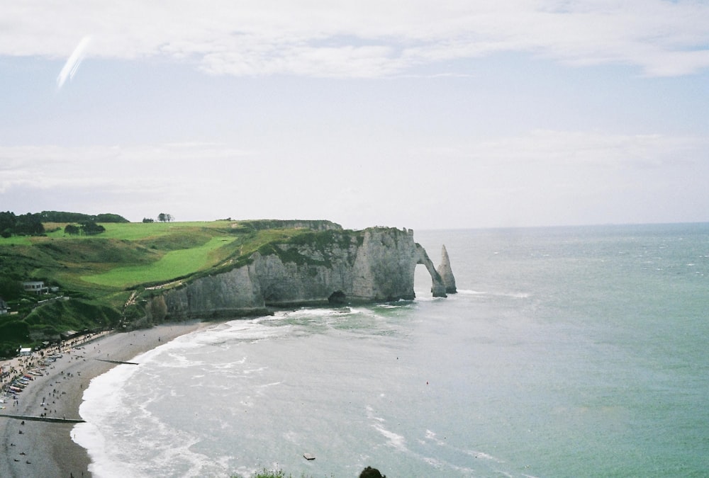 a view of a beach with a cliff in the background