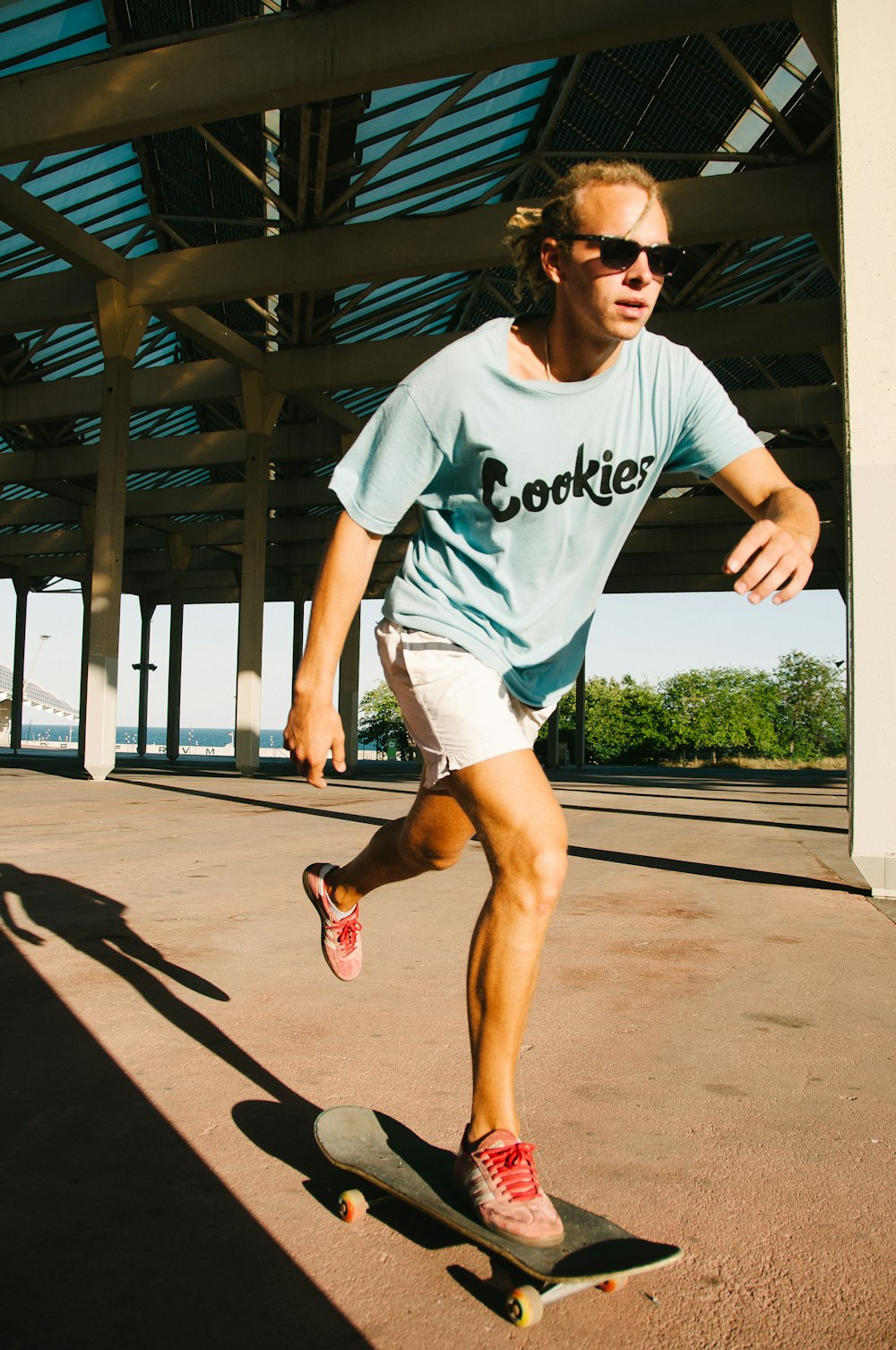 a man riding a skateboard down a sidewalk