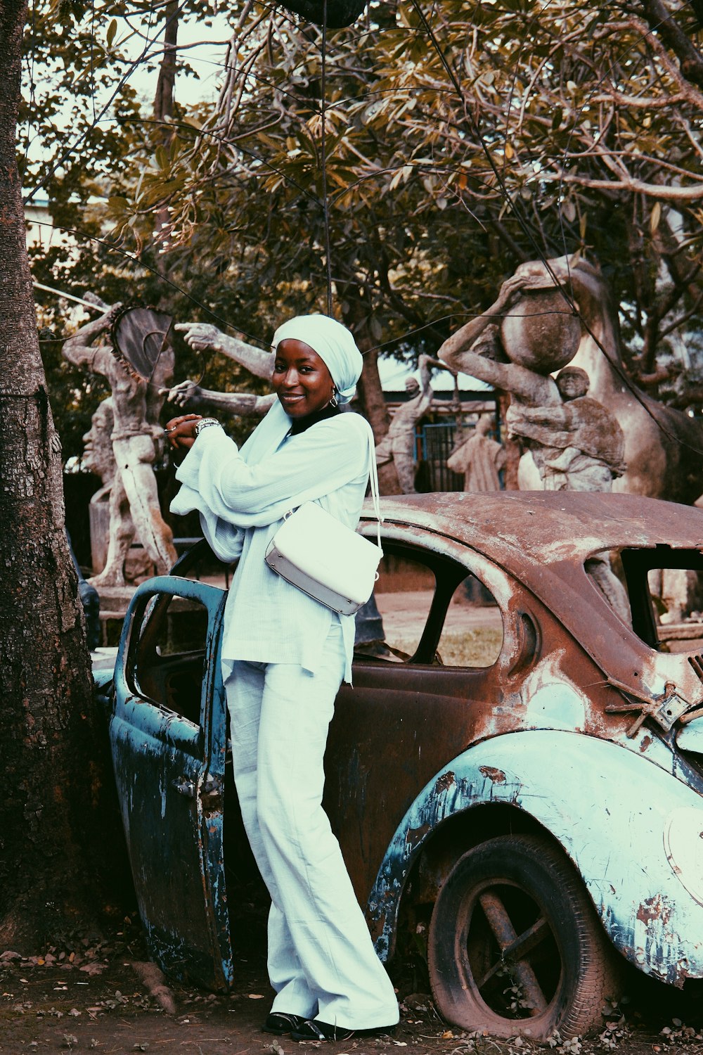 a man standing next to an old car