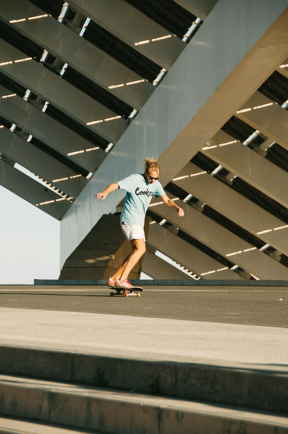 a man riding a skateboard down a flight of stairs