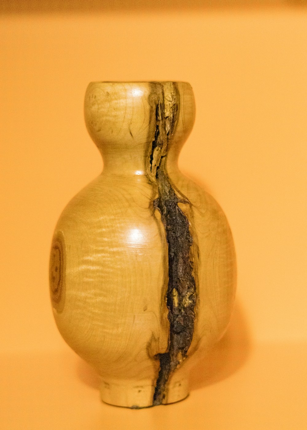 a wooden vase sitting on top of a table
