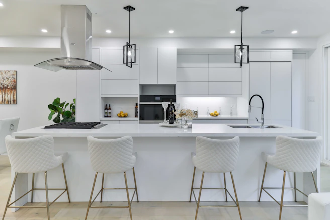 a kitchen with a center island with four bar stools