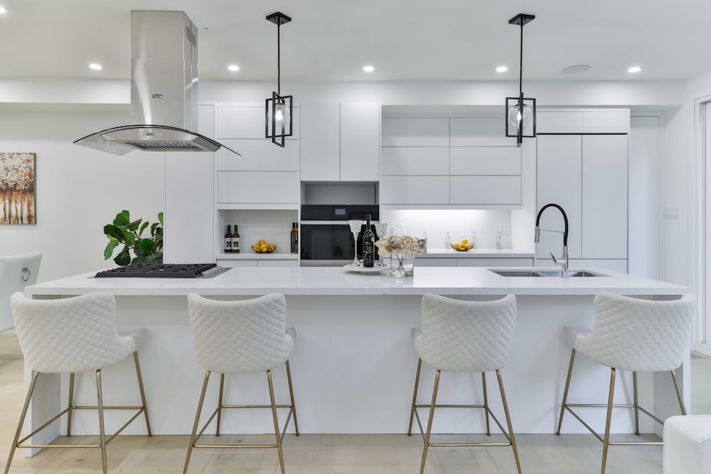 a kitchen with a center island with four bar stools