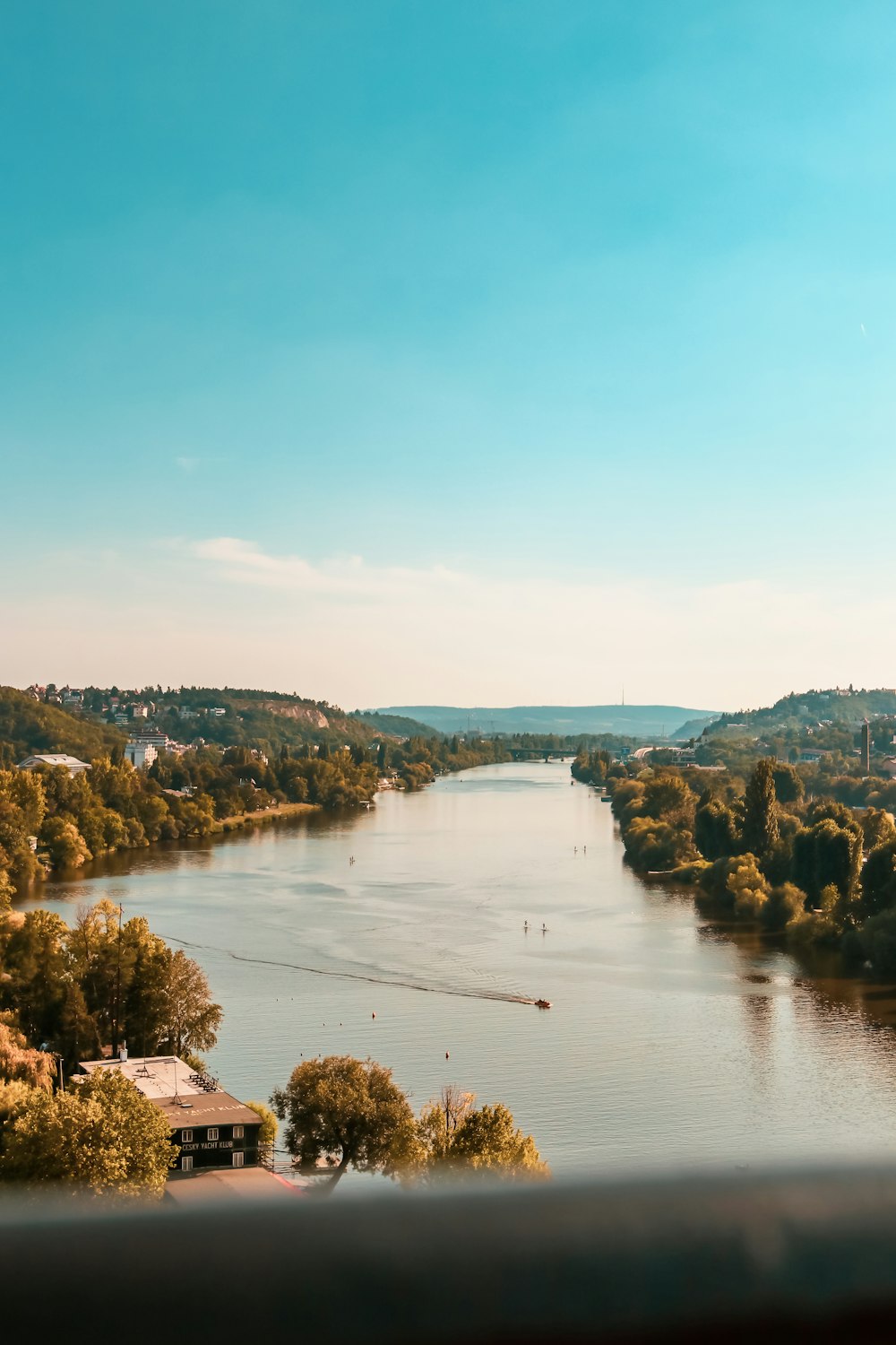 a body of water surrounded by trees and buildings