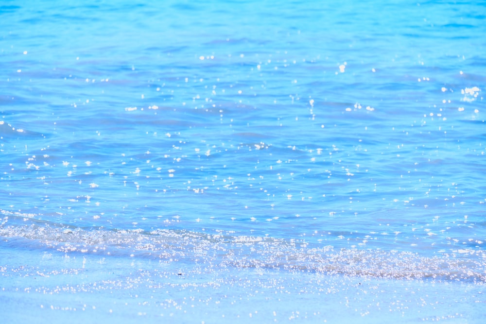 a close up of the water on a beach