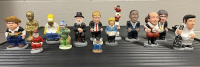 A collection of small rubber superhero figurines standing in a row