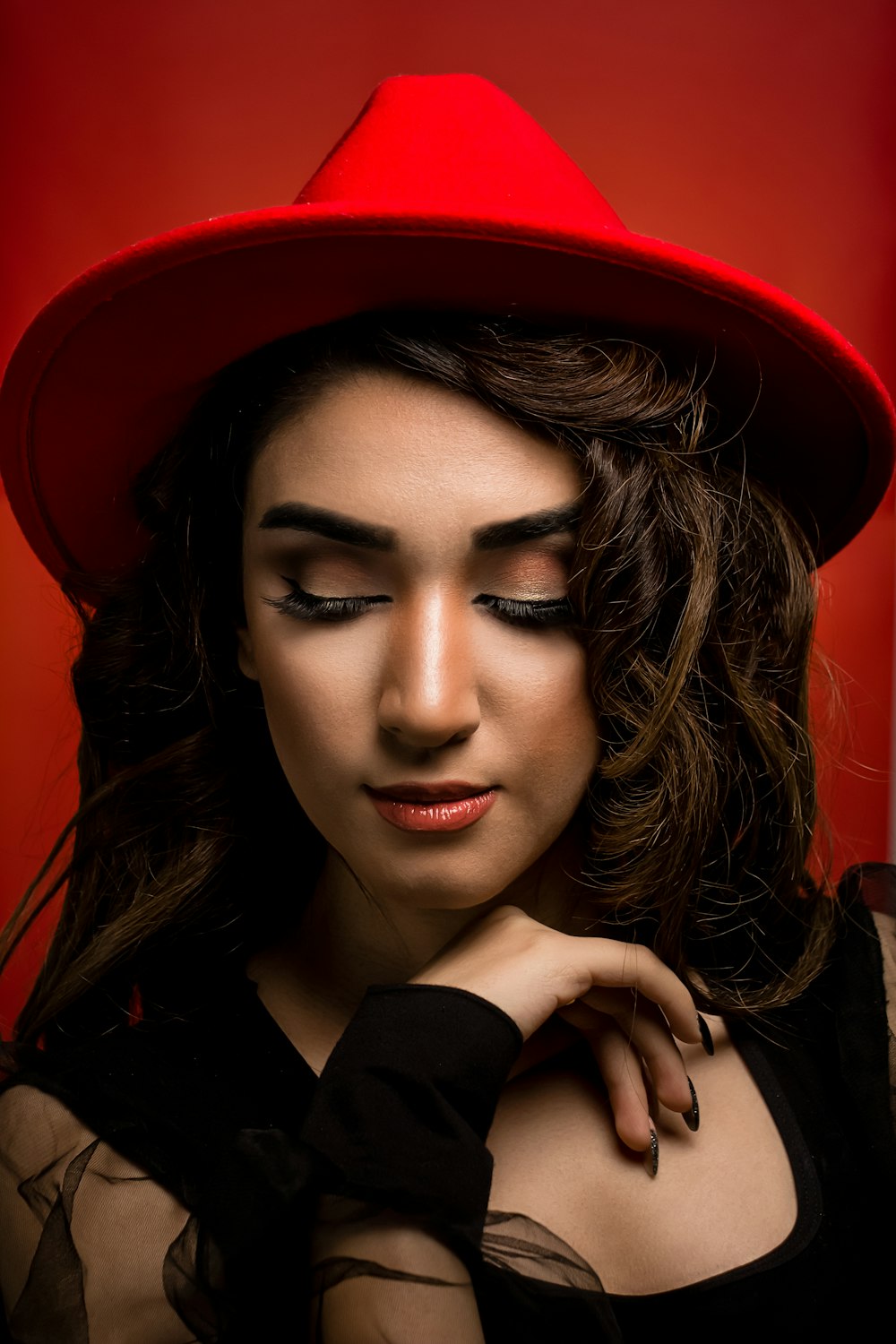 a woman wearing a red hat and black dress