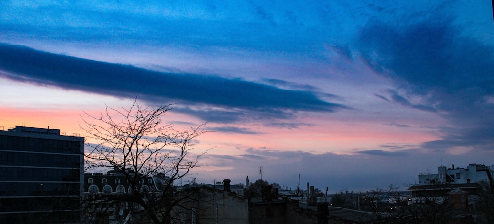 a view of a city at sunset from a rooftop