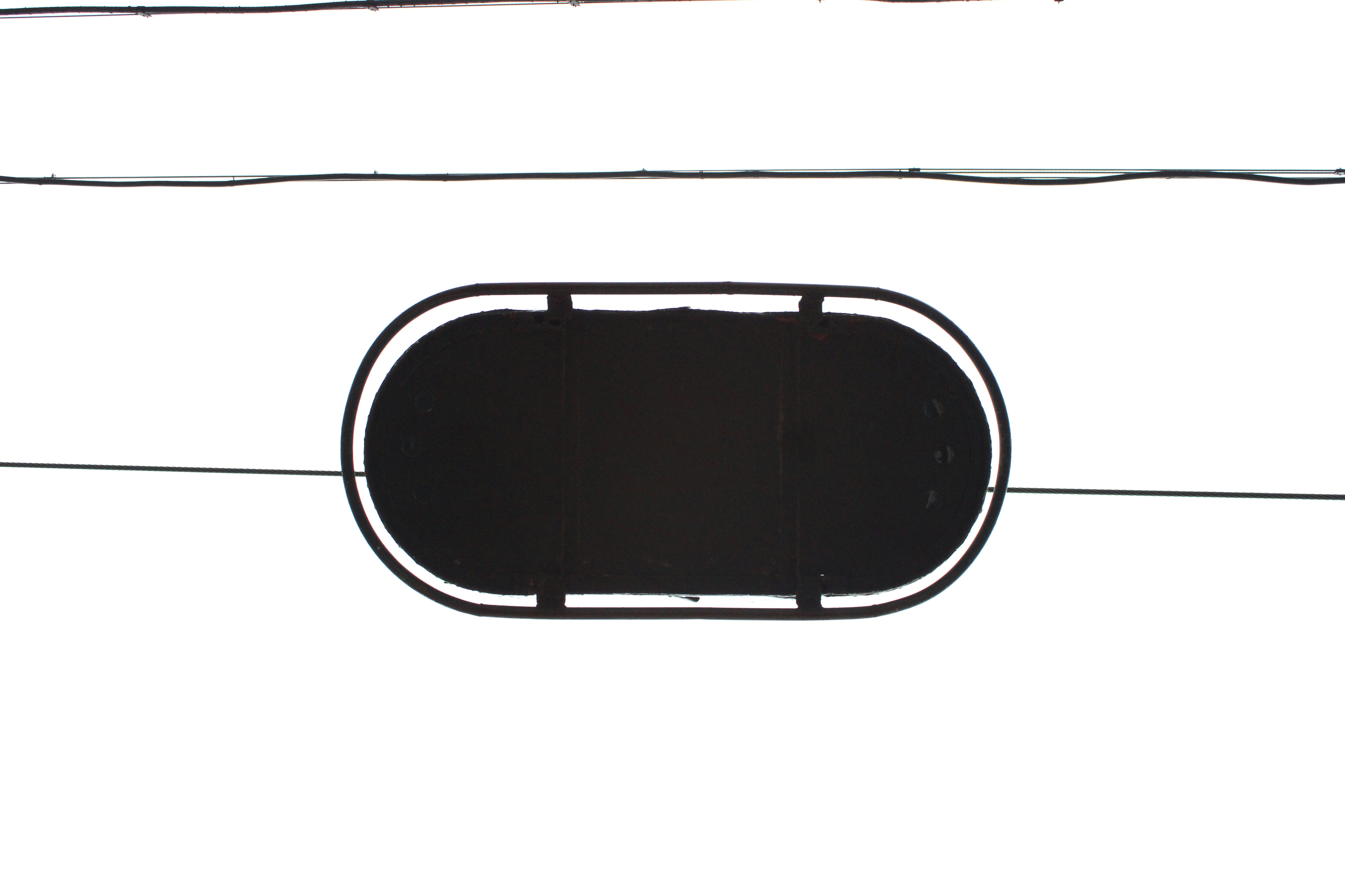 a picture of a black object hanging on a wire