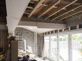a room that has a ladder and a window in it