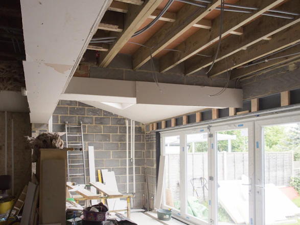 a room that has a ladder and a window in it
