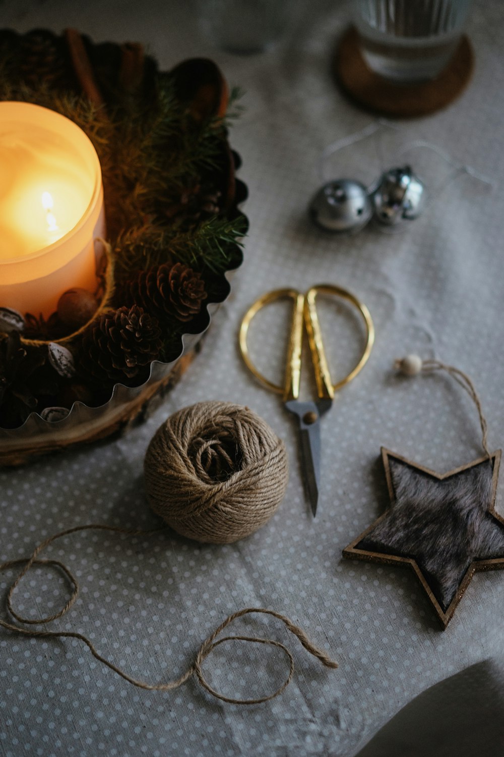 a close up of a table with a candle and scissors