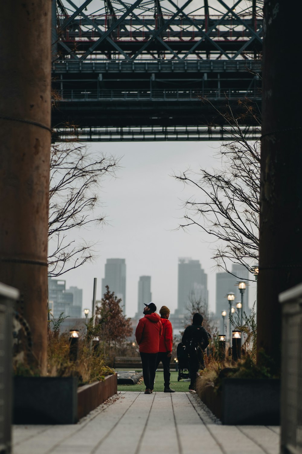 a couple of people walking down a walkway