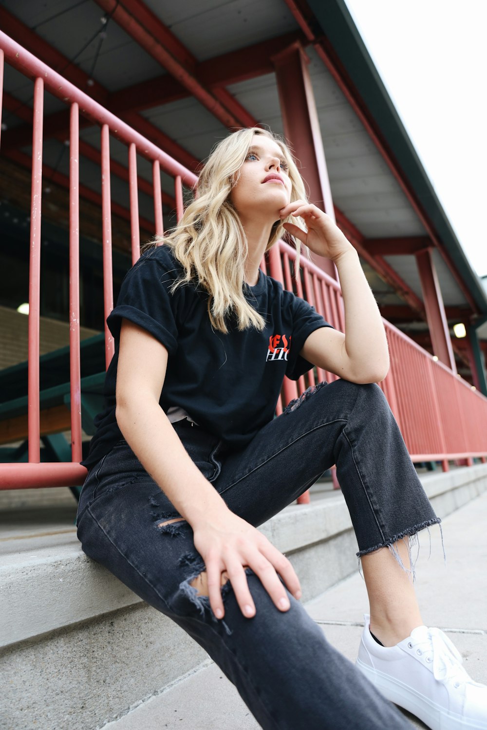 a woman sitting on the steps of a building