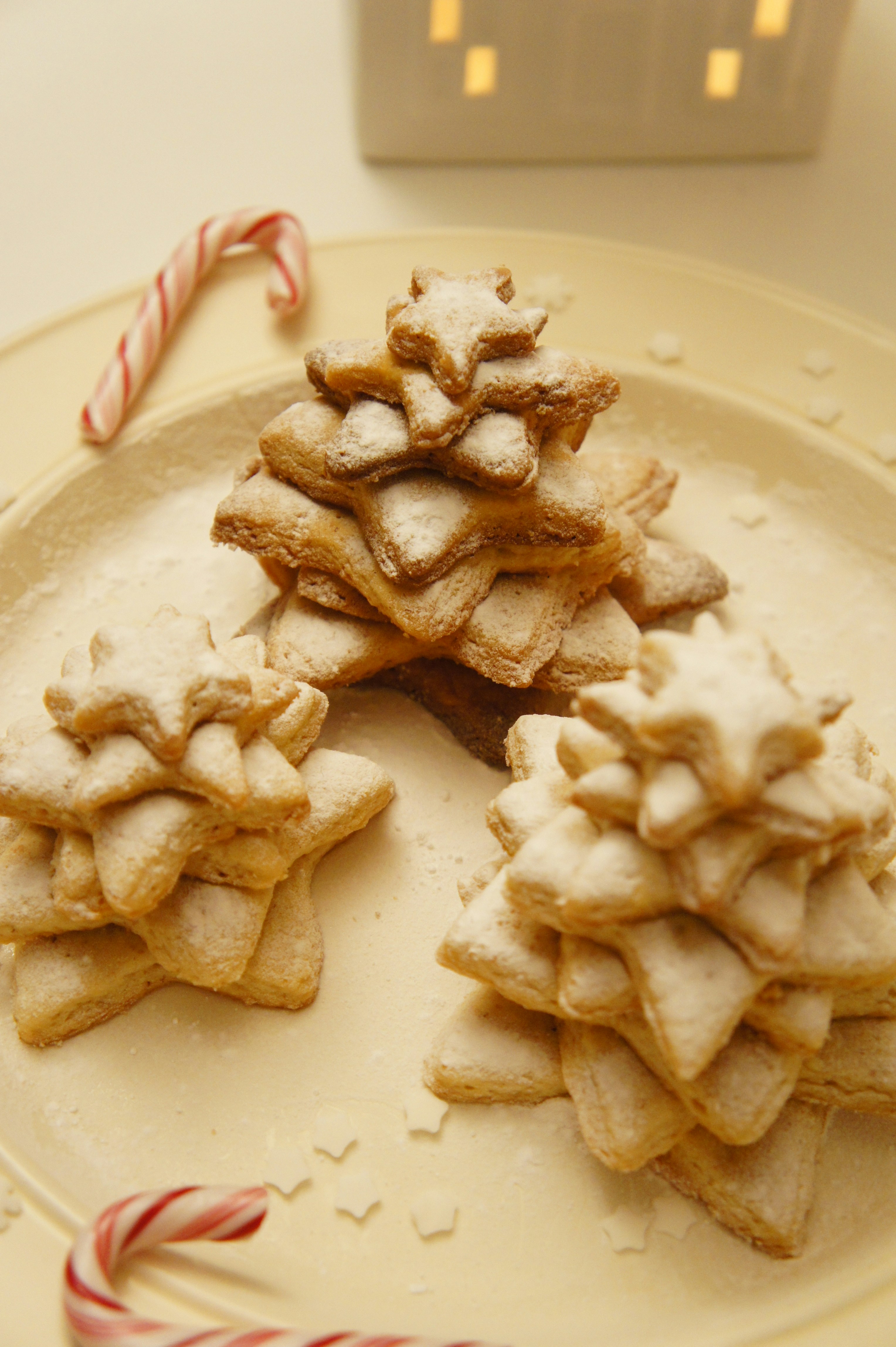 a plate of cookies and candy canes on a table