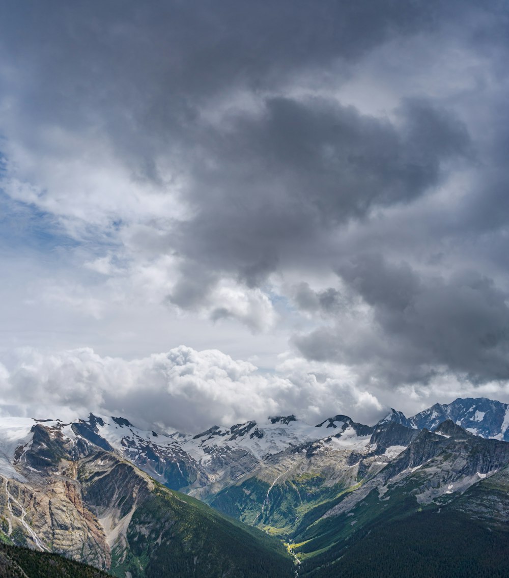 a view of a mountain range with a cloudy sky