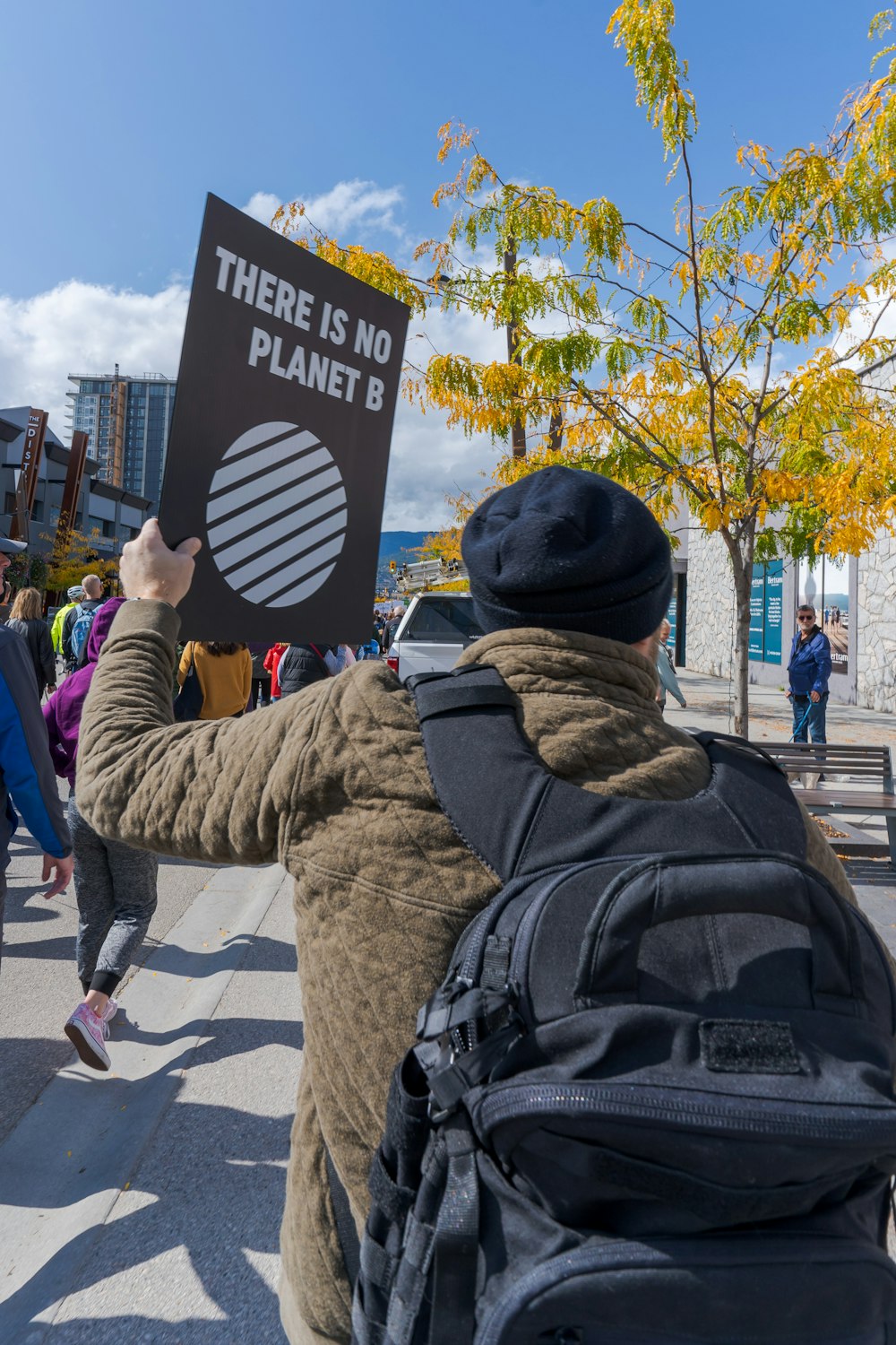 a person holding a sign that says there is no planet b