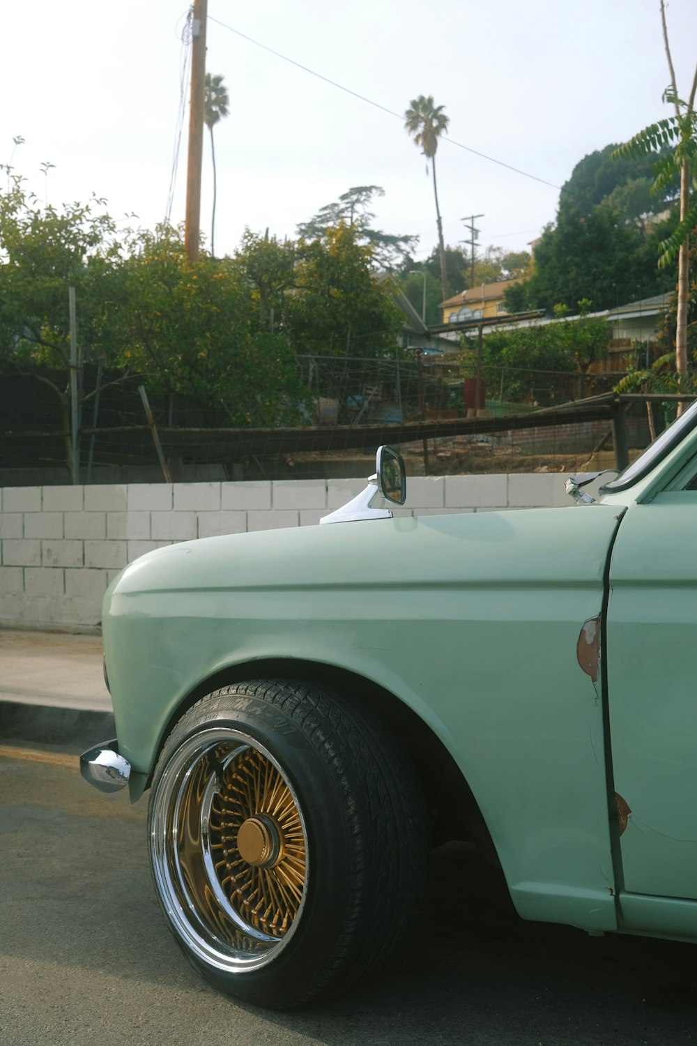 a green car parked on the side of the road