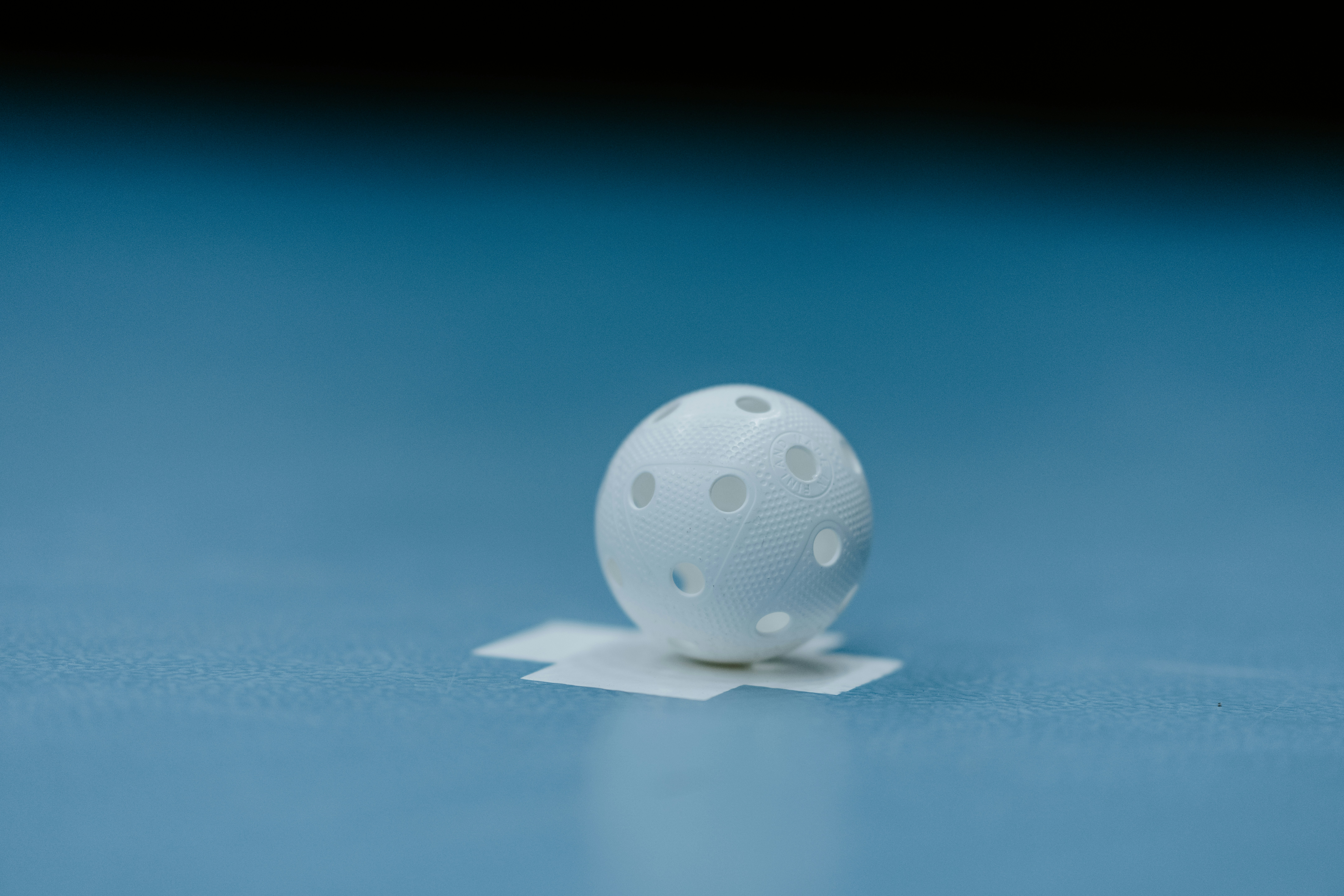 a white object sitting on top of a blue surface
