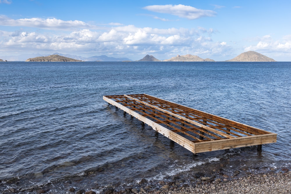 a wooden raft floating on top of a body of water