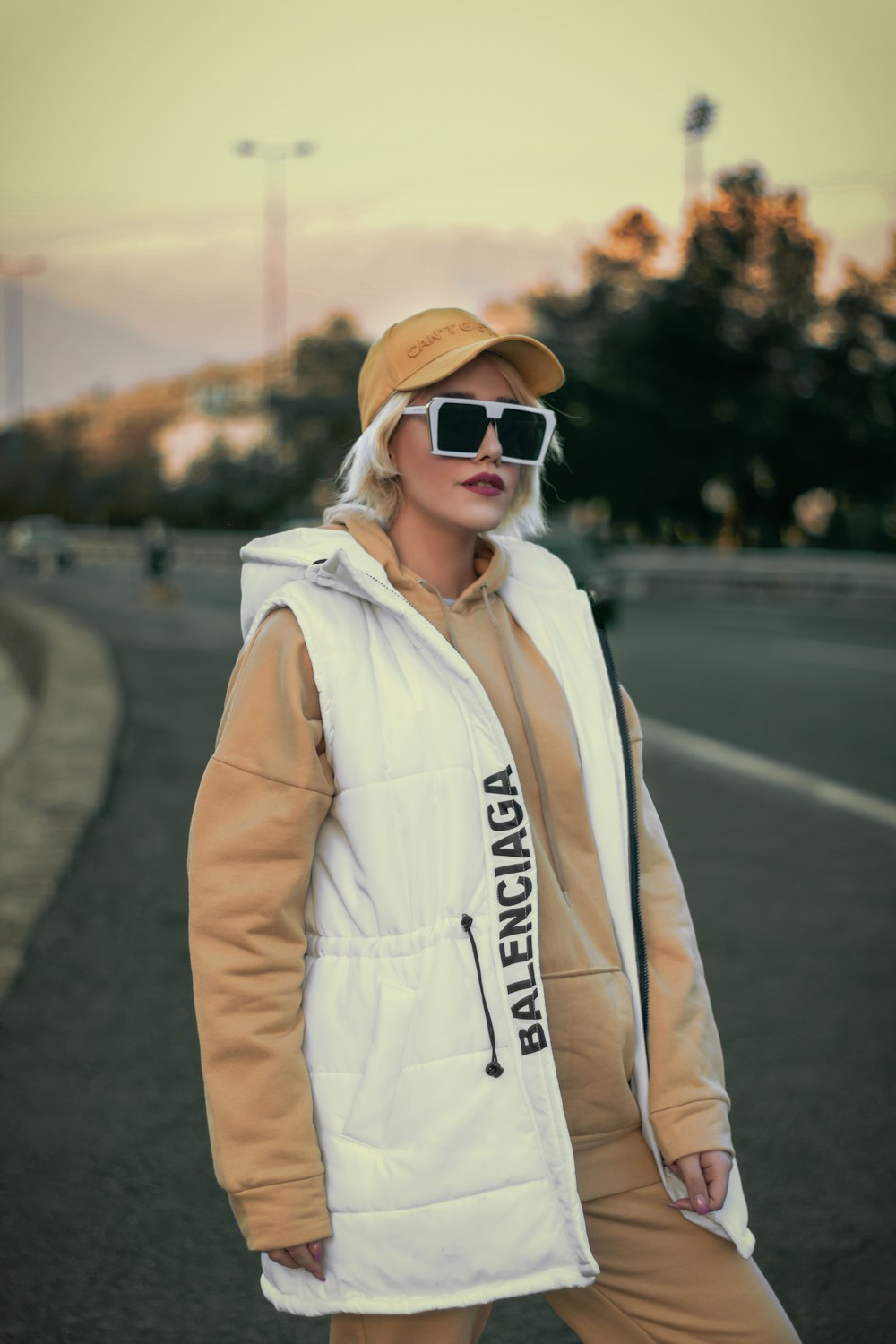 a woman wearing sunglasses and a hooded jacket