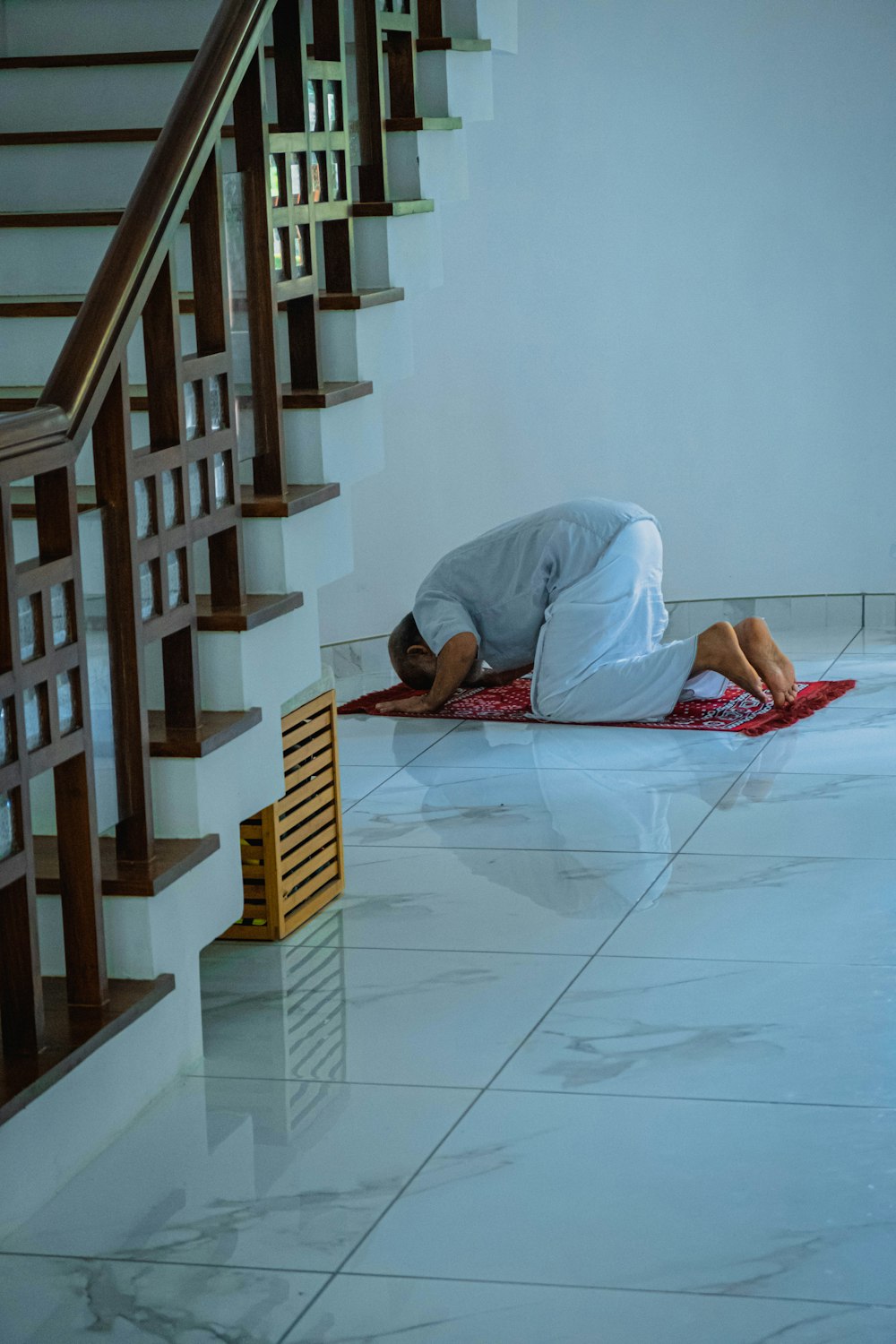 a person laying on a rug in a room