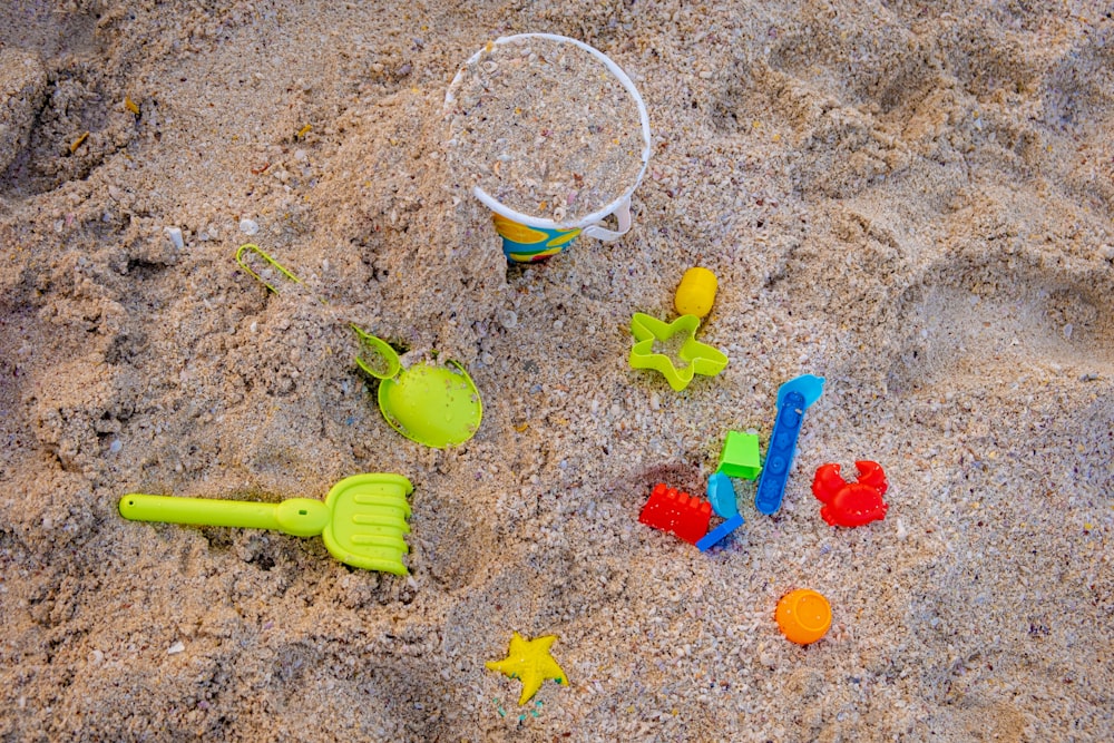 a beach with toys and a bucket of sand