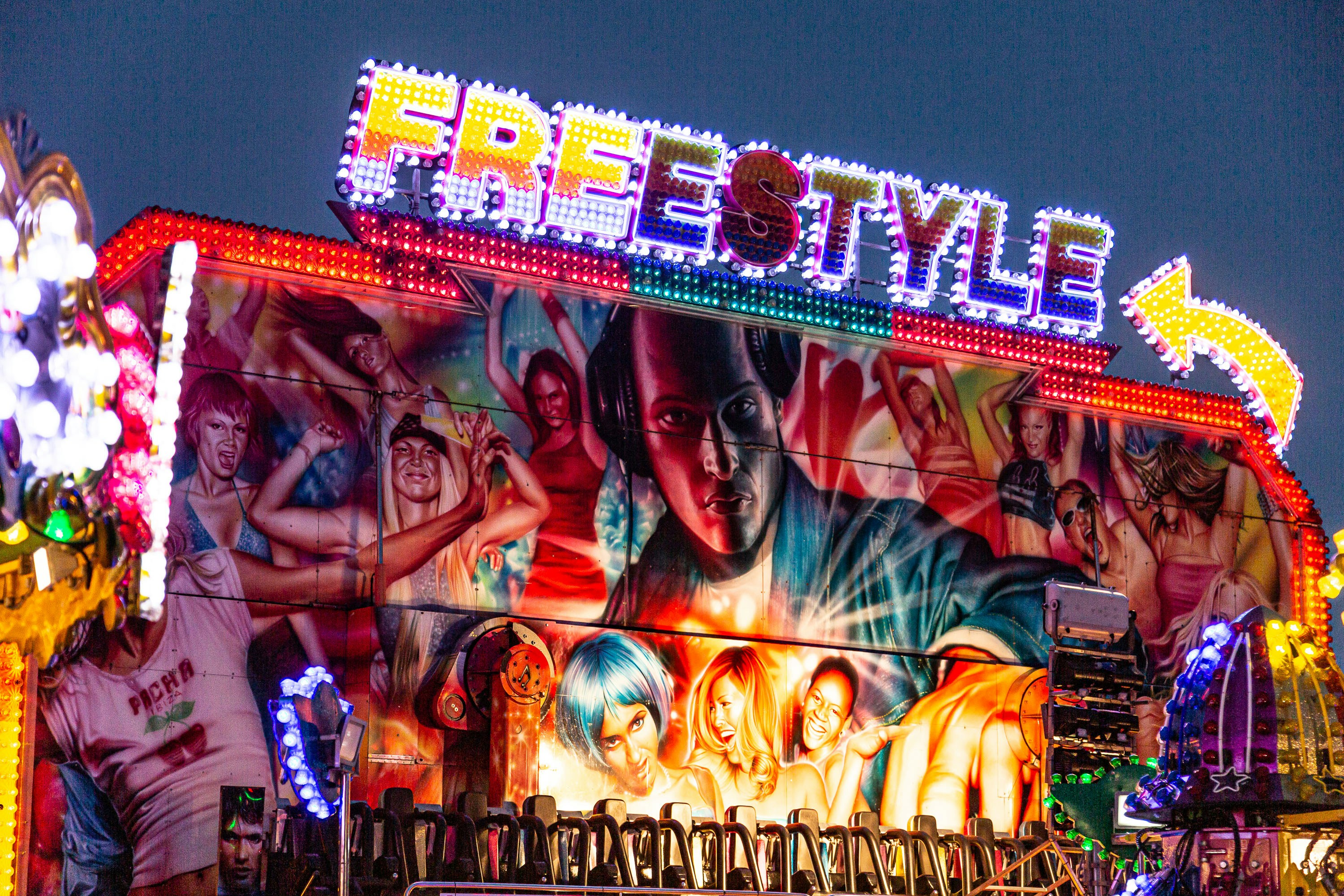 A carnival ride at night with a lot of people on it photo – Free Holmes ...