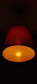 A red lamp casting a warm glow in a dim room.