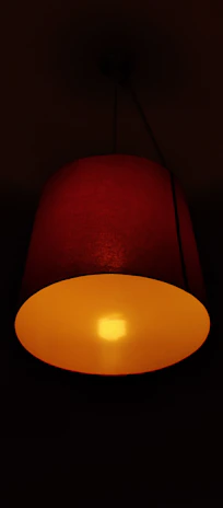 A softly glowing lamp casting a warm yellow glow over a quiet nook.