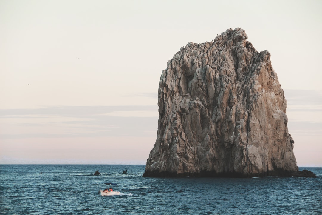 a large rock in the middle of the ocean,