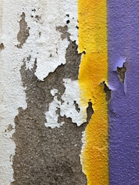 a close up of a wall with peeling paint